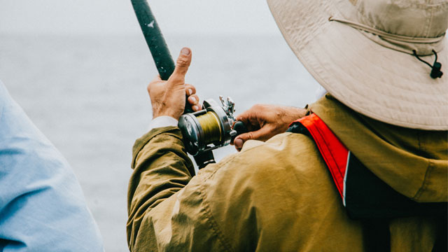 Fisherman reeling in a fish