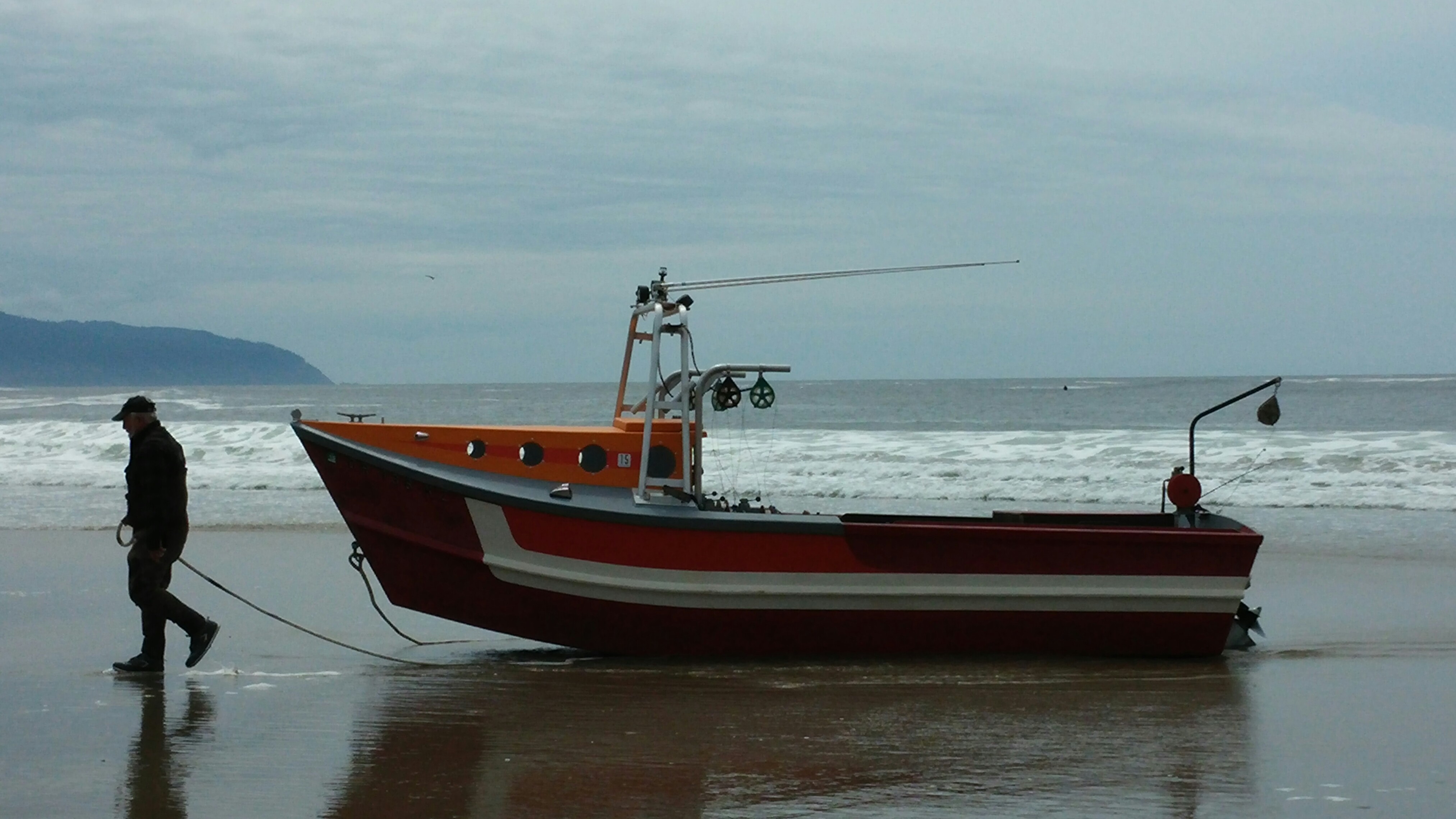 A dory fisherman brings in his boat in Pacific City, Oregon.