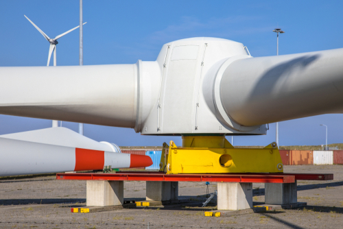 Picture of a wind turbine on the ground in shipping yard.